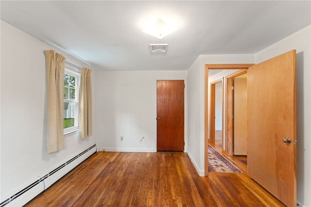 15 Rutland St, Warwick, RI 02888 - unfurnished bedroom featuring baseboard heating, wood finished floors, and a closet