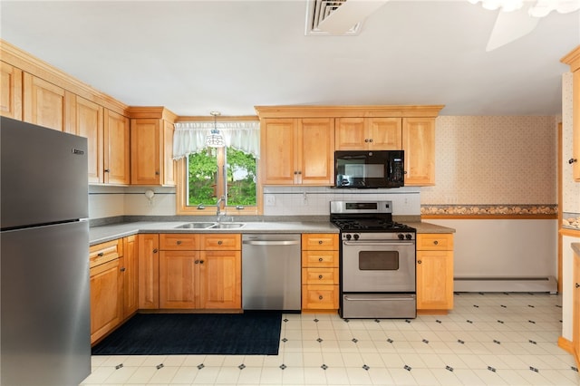 15 Rutland St, Warwick, RI 02888 - kitchen featuring appliances with stainless steel finishes, light floors, a baseboard radiator, wallpapered walls, and a wainscoted wall