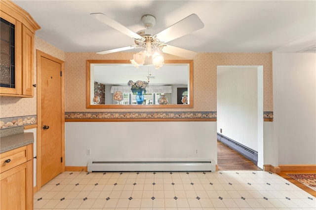 15 Rutland St, Warwick, RI 02888 - dining space featuring a baseboard heating unit, light floors, wallpapered walls, and ceiling fan