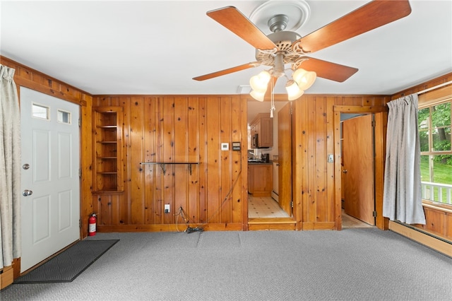 15 Rutland St, Warwick, RI 02888 - carpeted entrance foyer featuring wooden walls, a ceiling fan, and a baseboard heating unit