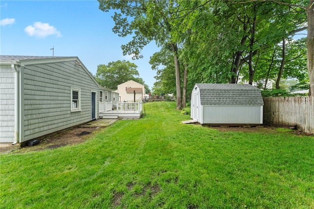 15 Rutland St, Warwick, RI 02888 - fenced backyard featuring a storage unit and a wooden deck