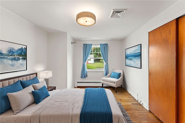 15 Rutland St, Warwick, RI 02888 - bedroom featuring a baseboard radiator and light wood-style floors