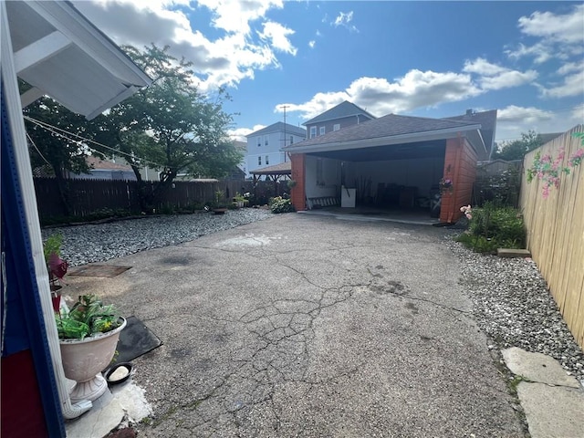 64 Elmdale Ave, Providence, RI 02909 - view of home's exterior featuring a fenced backyard, driveway, and a shingled roof
