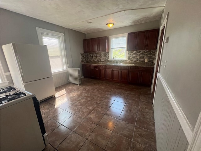 64 Elmdale Ave, Providence, RI 02909 - kitchen featuring white appliances, radiator heating unit, and decorative backsplash