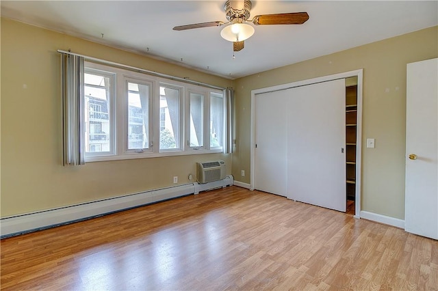 400 Narragansett Pkwy Unit Ei 2, Warwick, RI 02888 - unfurnished bedroom featuring a baseboard heating unit, light wood-style flooring, a closet, a wall mounted air conditioner, and a ceiling fan