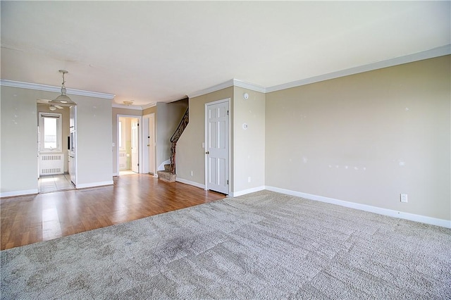 400 Narragansett Pkwy Unit Ei 2, Warwick, RI 02888 - unfurnished room featuring radiator, carpet, ornamental molding, wood finished floors, and stairs