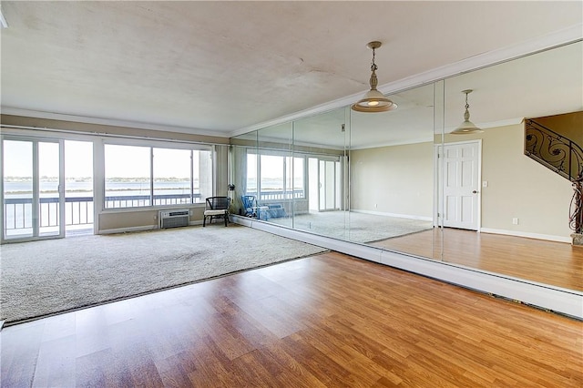 400 Narragansett Pkwy Unit Ei 2, Warwick, RI 02888 - spare room with crown molding, wood finished floors, a wall unit AC, and a water view
