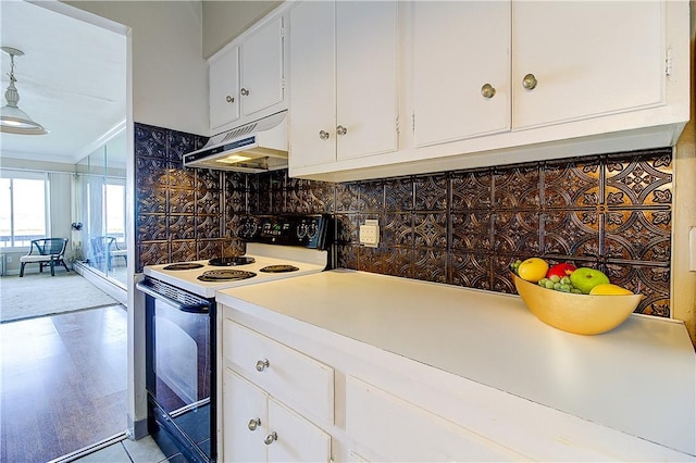 400 Narragansett Pkwy Unit Ei 2, Warwick, RI 02888 - kitchen with range with electric stovetop, under cabinet range hood, white cabinetry, light countertops, and decorative backsplash