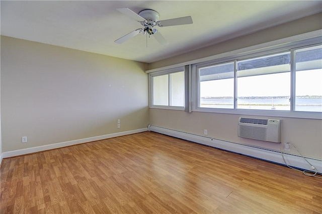 400 Narragansett Pkwy Unit Ei 2, Warwick, RI 02888 - unfurnished room with baseboard heating, a wall mounted AC, light wood-type flooring, and ceiling fan