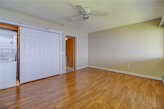 400 Narragansett Pkwy Unit Ei 2, Warwick, RI 02888 - unfurnished bedroom featuring estacked washer and dryer, light wood finished floors, a closet, and ceiling fan