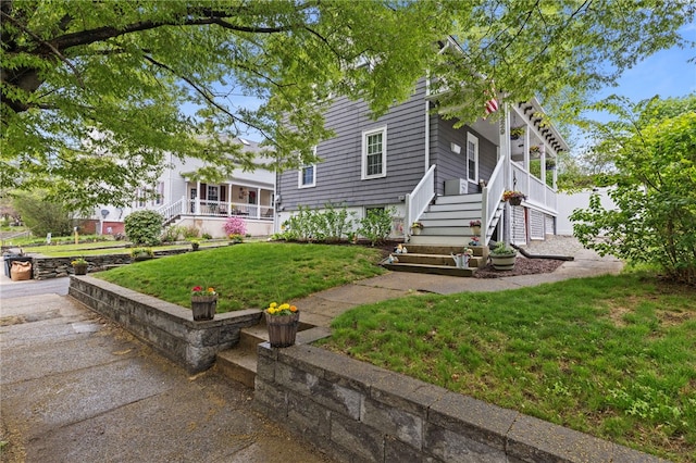 229 Roger Williams Ave, East Providence, RI 02916 - view of front of property with stairs, a front yard, and covered porch