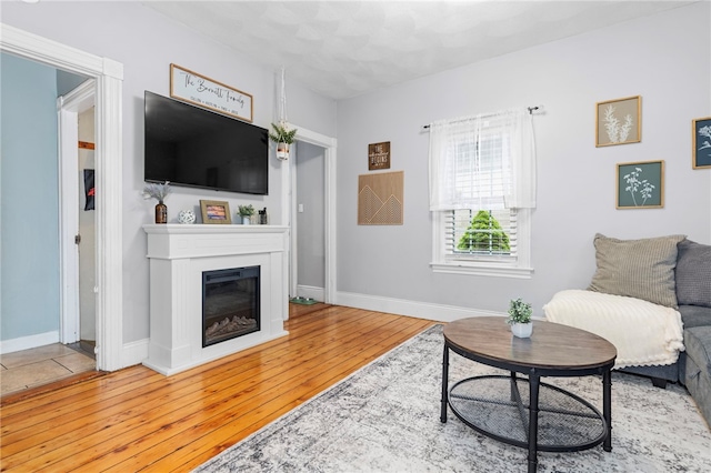 229 Roger Williams Ave, East Providence, RI 02916 - living area featuring hardwood / wood-style flooring and a glass covered fireplace