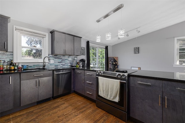 94 Waterman Ave, Warwick, RI 02889 - kitchen with stainless steel appliances, lofted ceiling, tasteful backsplash, dark wood-type flooring, and a peninsula