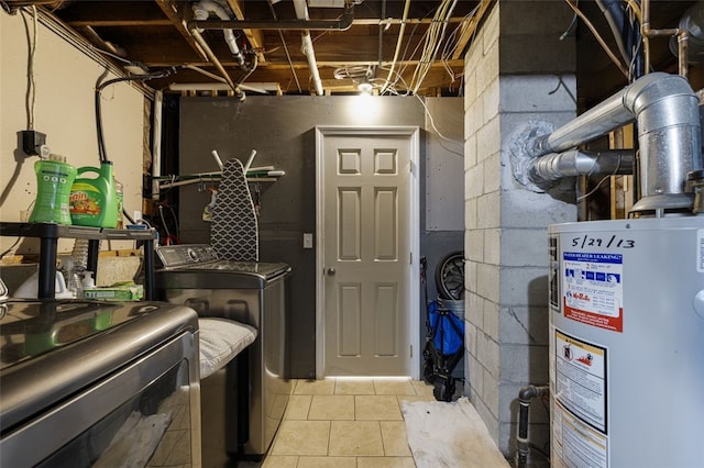 94 Waterman Ave, Warwick, RI 02889 - washroom featuring gas water heater, washer and clothes dryer, and light tile patterned floors