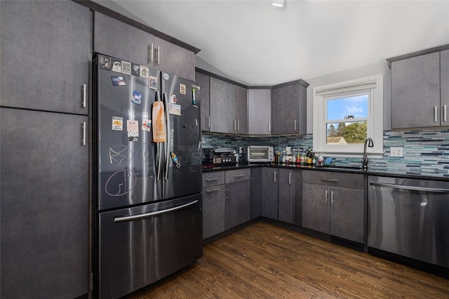 94 Waterman Ave, Warwick, RI 02889 - kitchen with stainless steel appliances, dark countertops, tasteful backsplash, dark wood-style flooring, and vaulted ceiling