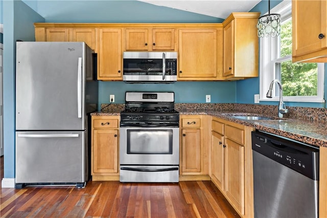 11 Tupelo Trl, Narragansett, RI 02882 - kitchen with stainless steel appliances, dark wood-style floors, dark stone countertops, lofted ceiling, and hanging light fixtures