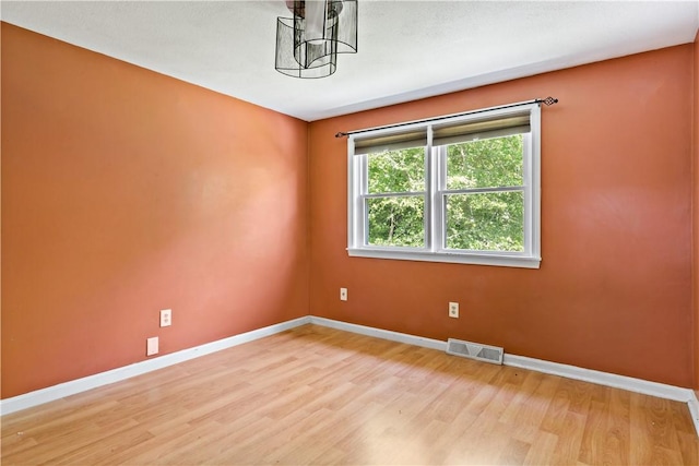 11 Tupelo Trl, Narragansett, RI 02882 - unfurnished room with light wood-type flooring and a chandelier