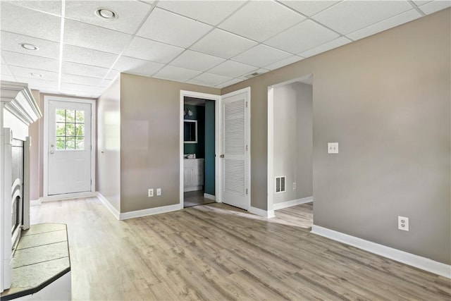 11 Tupelo Trl, Narragansett, RI 02882 - unfurnished living room featuring light wood finished floors, a drop ceiling, and recessed lighting