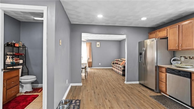 26 Grafton St Unit 3, Providence, RI 02904 - kitchen with stainless steel appliances, tasteful backsplash, light wood-style floors, recessed lighting, and brown cabinetry