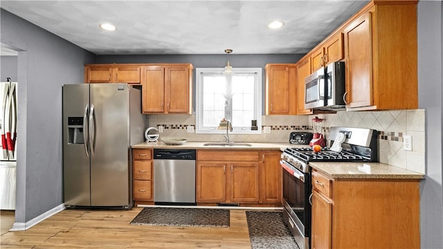 26 Grafton St Unit 3, Providence, RI 02904 - kitchen with appliances with stainless steel finishes, light wood-style flooring, recessed lighting, backsplash, and brown cabinetry