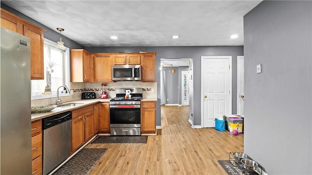 26 Grafton St Unit 3, Providence, RI 02904 - kitchen featuring stainless steel appliances, light wood-style floors, light countertops, recessed lighting, and backsplash
