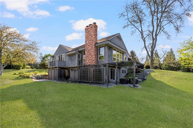 11 Mill Brook Ct, Charlestown, RI 02813 - rear view of property with a lawn, a chimney, a wooden deck, and a patio