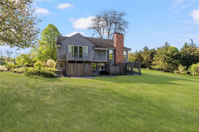 11 Mill Brook Ct, Charlestown, RI 02813 - rear view of house featuring a chimney and a lawn