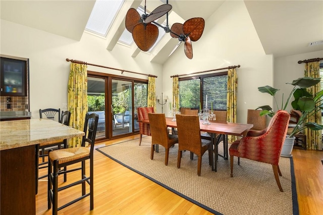 11 Mill Brook Ct, Charlestown, RI 02813 - dining room featuring plenty of natural light, high vaulted ceiling, a skylight, and light wood finished floors