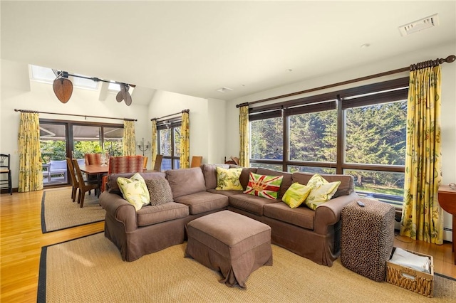 11 Mill Brook Ct, Charlestown, RI 02813 - living area with healthy amount of natural light, wood finished floors, and lofted ceiling