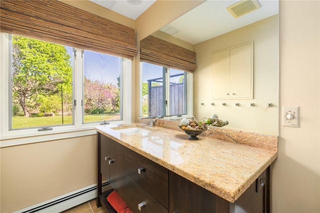 11 Mill Brook Ct, Charlestown, RI 02813 - kitchen featuring a baseboard heating unit, plenty of natural light, and dark brown cabinetry