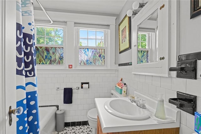 112 County Rd, Barrington, RI 02806 - full bath with vanity, shower / tub combo with curtain, tile walls, tile patterned floors, and a wainscoted wall