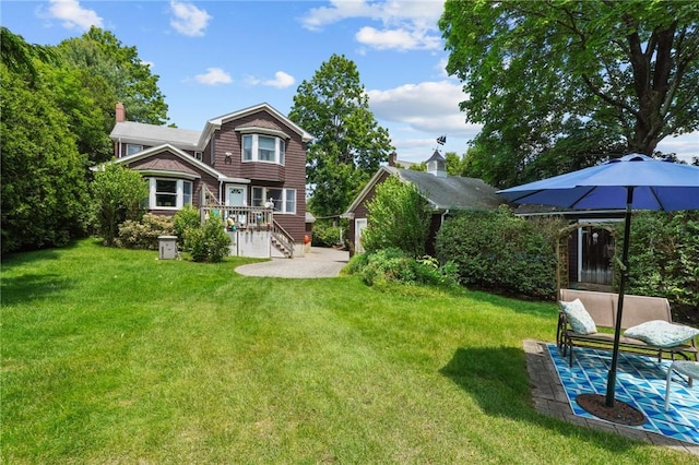 112 County Rd, Barrington, RI 02806 - rear view of property with a chimney, a lawn, a wooden deck, and a patio