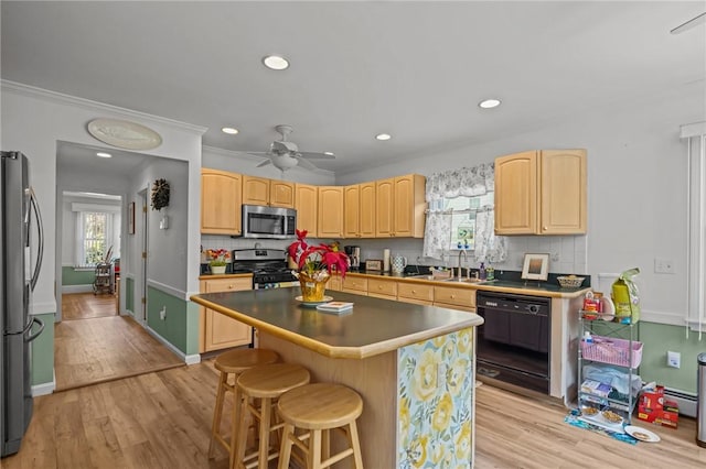 112 County Rd, Barrington, RI 02806 - kitchen with stainless steel appliances, light brown cabinets, light wood finished floors, backsplash, and a kitchen breakfast bar