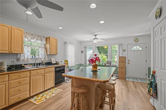 112 County Rd, Barrington, RI 02806 - kitchen with a ceiling fan, black dishwasher, light brown cabinets, a breakfast bar area, and plenty of natural light