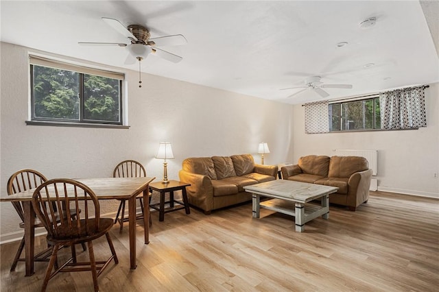 401 Bellevue Ave Unit 100, Newport, RI 02840 - living area with ceiling fan, radiator, and light wood finished floors