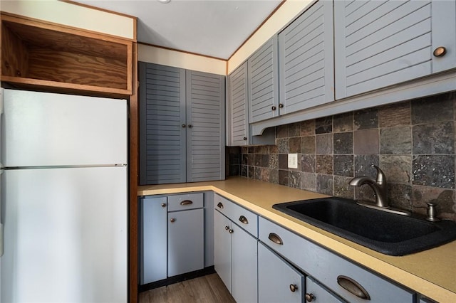 401 Bellevue Ave Unit 100, Newport, RI 02840 - kitchen with freestanding refrigerator, light countertops, decorative backsplash, and gray cabinetry