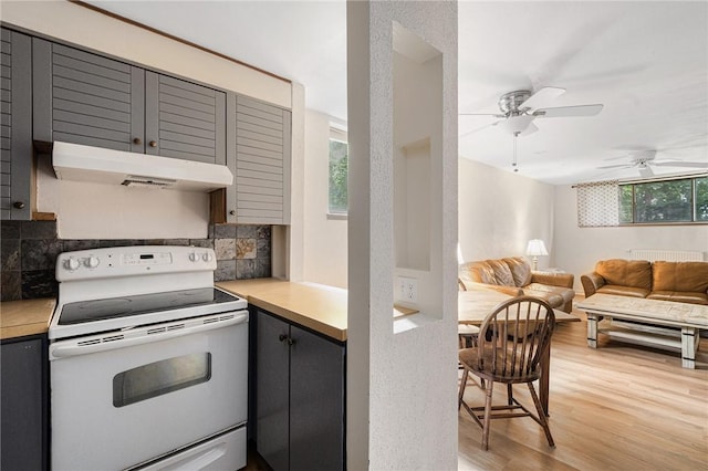 401 Bellevue Ave Unit 100, Newport, RI 02840 - kitchen with white electric range, under cabinet range hood, gray cabinets, light countertops, and light wood-type flooring