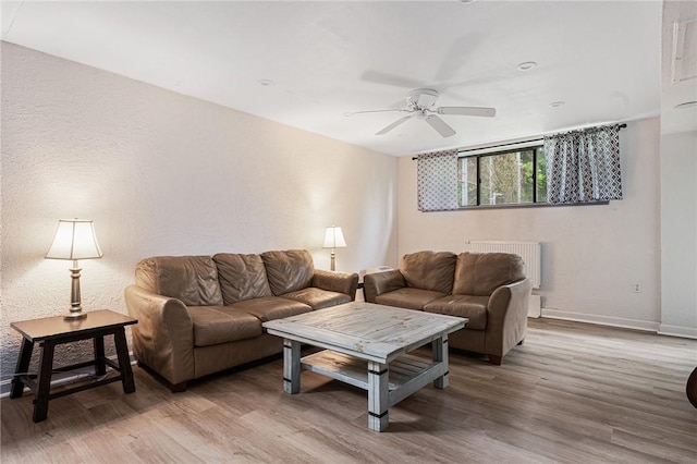 401 Bellevue Ave Unit 100, Newport, RI 02840 - living area featuring radiator, a ceiling fan, and wood finished floors
