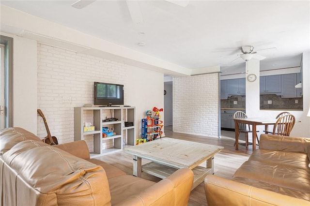 401 Bellevue Ave Unit 100, Newport, RI 02840 - living room with ceiling fan, wood finished floors, and brick wall