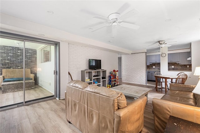 401 Bellevue Ave Unit 100, Newport, RI 02840 - living area with ceiling fan, light wood-style floors, and brick wall