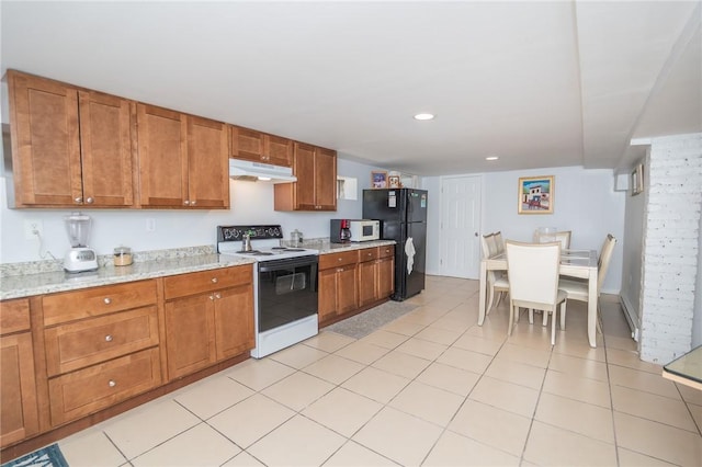 201 Hillcrest Ave, Providence, RI 02909 - kitchen with range with electric stovetop, under cabinet range hood, freestanding refrigerator, white microwave, and brown cabinetry