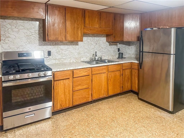 253 Nelson St, Providence, RI 02908 - kitchen with stainless steel appliances, light countertops, brown cabinetry, and decorative backsplash