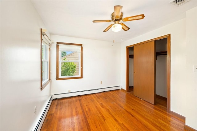 253 Nelson St, Providence, RI 02908 - unfurnished bedroom with a baseboard radiator, wood finished floors, and a ceiling fan