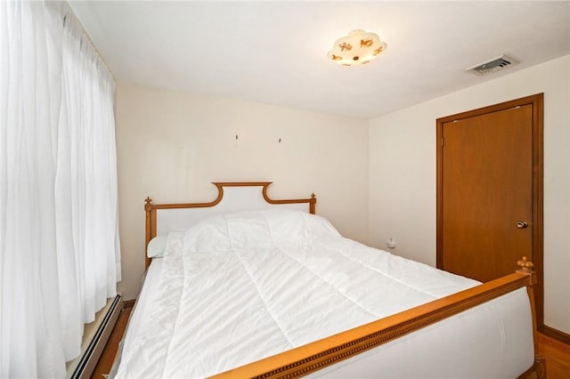 253 Nelson St, Providence, RI 02908 - bedroom featuring wood finished floors and a baseboard heating unit