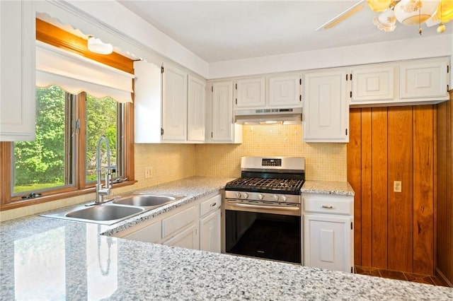 253 Nelson St, Providence, RI 02908 - kitchen featuring gas stove, ventilation hood, white cabinets, and decorative backsplash
