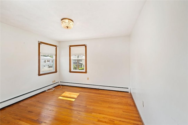 253 Nelson St, Providence, RI 02908 - empty room with a baseboard heating unit and wood finished floors