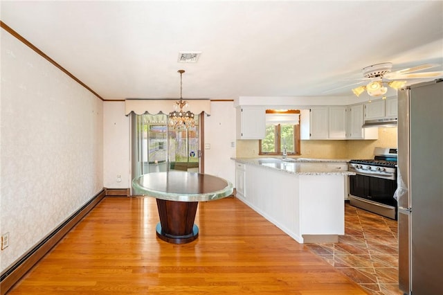 253 Nelson St, Providence, RI 02908 - kitchen featuring stainless steel appliances, under cabinet range hood, baseboard heating, a chandelier, and wallpapered walls