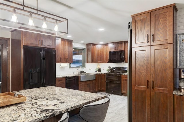 536 Douglas Hook Rd, Glocester, RI 02814 - kitchen with black appliances, light stone countertops, pendant lighting, and recessed lighting