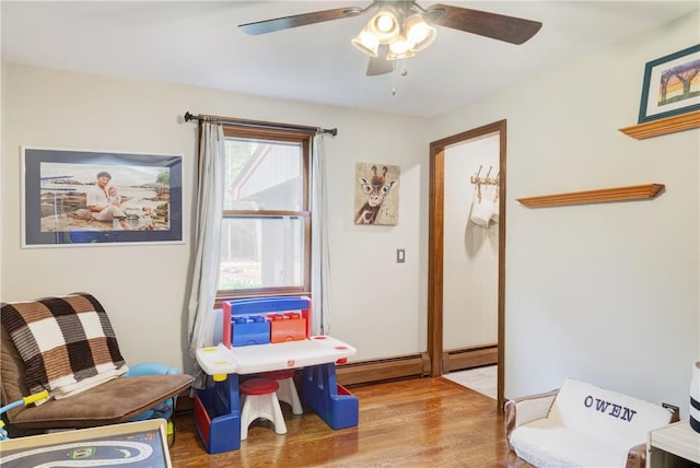 536 Douglas Hook Rd, Glocester, RI 02814 - living area featuring wood finished floors, a ceiling fan, and a baseboard heating unit