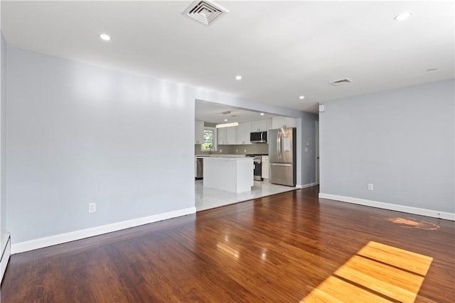 57 Wilson Ave, Johnston, RI 02919 - unfurnished living room featuring wood finished floors, recessed lighting, and a baseboard heating unit